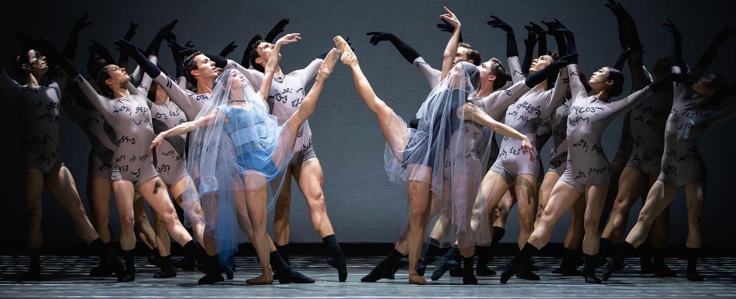 In white veils as they marry, held by Anne Litter's words represented by many dancers behind them